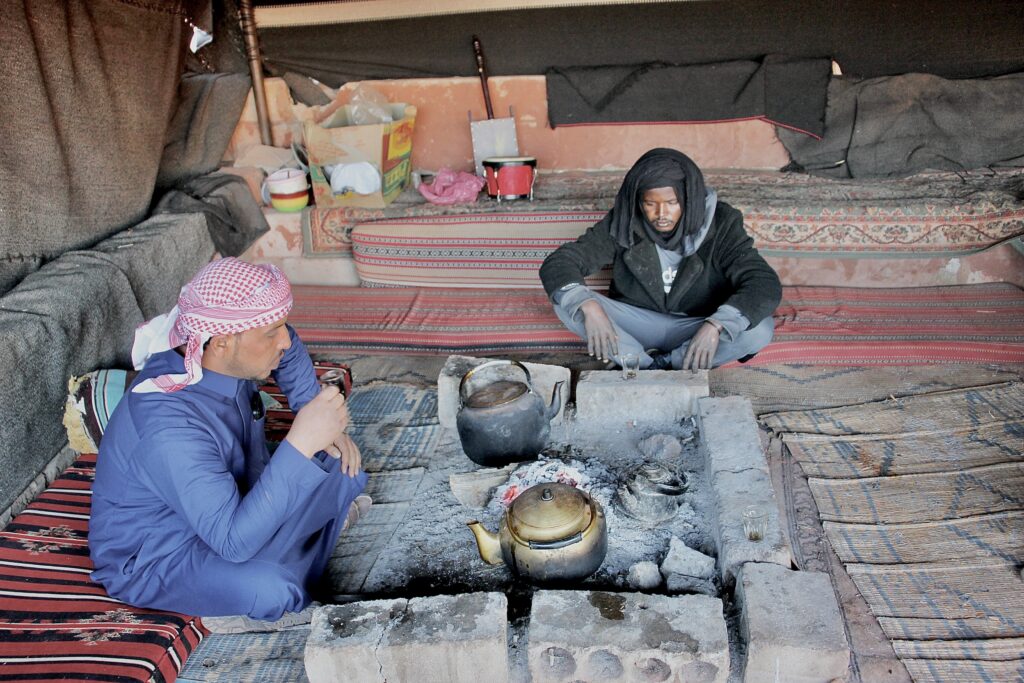 Bedouins drinking Arabic tea in caravan tent, Wadi Rum