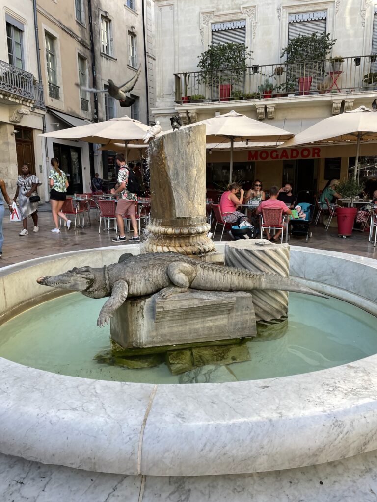 Alligator statue in the French city of Nîmes, as part of my travel guide